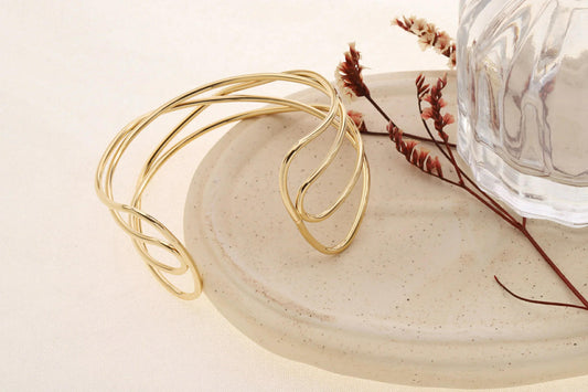 Bracelet manchette dorée ajustable 4 branches entrelacées